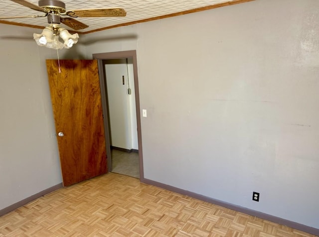 spare room with light parquet flooring and ceiling fan