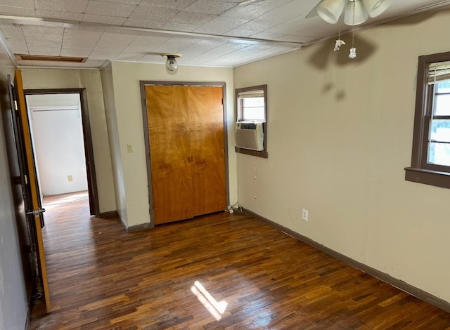 spare room with cooling unit and dark hardwood / wood-style floors