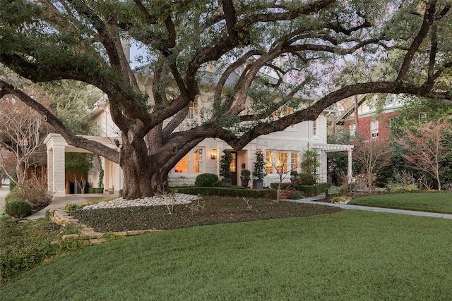 view of front of property with a front lawn and a pergola