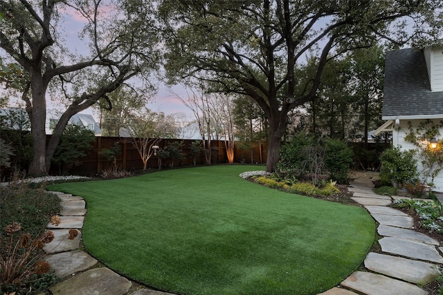 view of yard at dusk