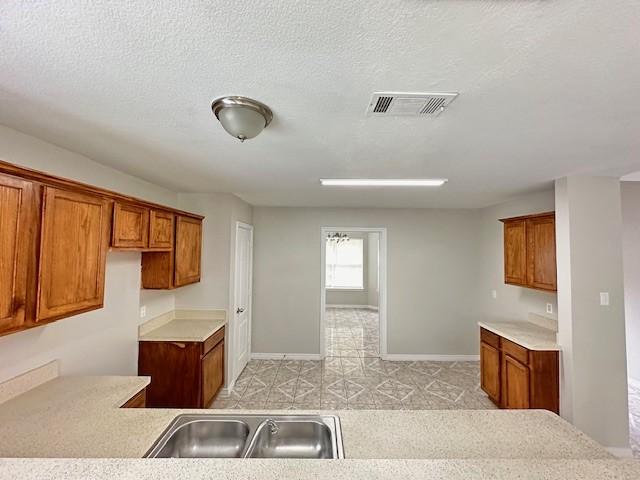 kitchen with sink and a textured ceiling