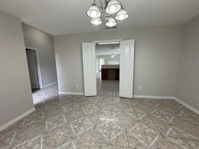 unfurnished dining area with a chandelier