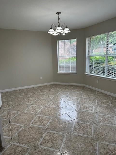 empty room featuring a chandelier