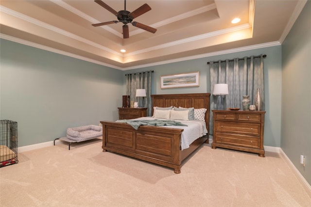 bedroom featuring a raised ceiling, ornamental molding, light carpet, and ceiling fan