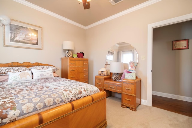 bedroom with ornamental molding, light colored carpet, and ceiling fan