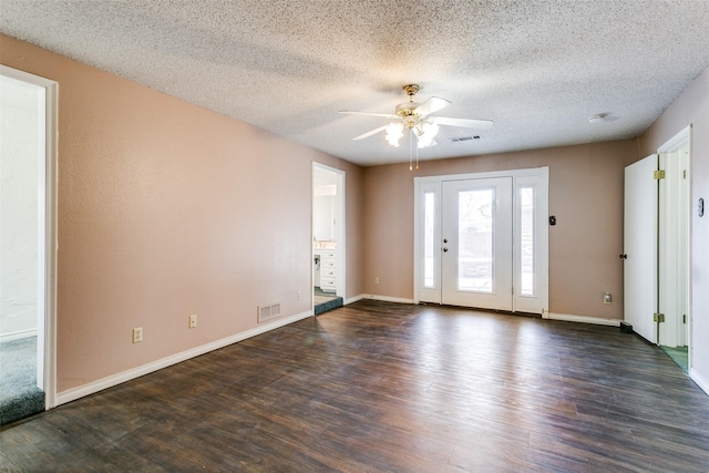 unfurnished room featuring dark wood-type flooring, a textured ceiling, and ceiling fan