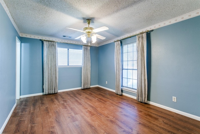 spare room with hardwood / wood-style flooring, ornamental molding, a textured ceiling, and ceiling fan