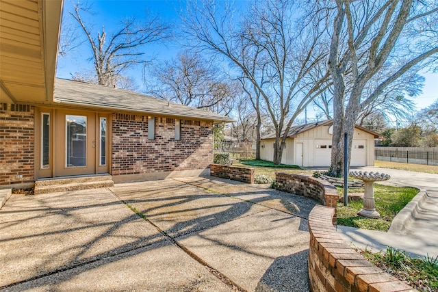 view of patio featuring a garage and an outdoor structure