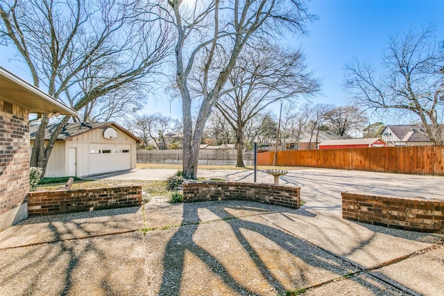 view of patio / terrace with a garage and an outdoor structure