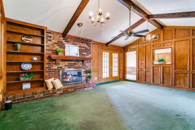 unfurnished living room with french doors, carpet flooring, a fireplace, and a textured ceiling