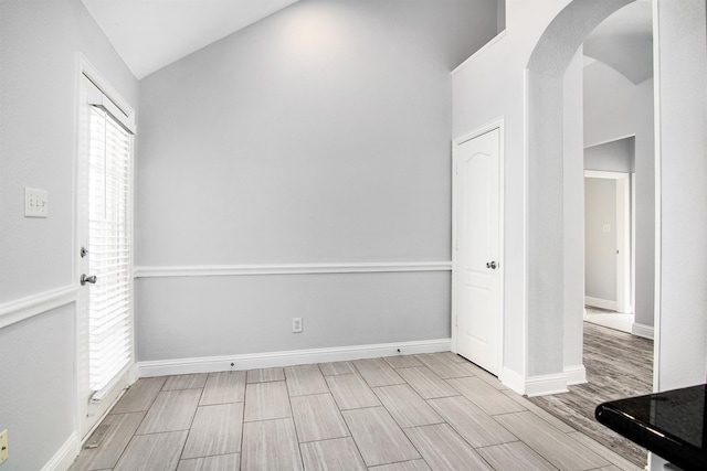 spare room featuring lofted ceiling