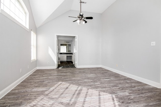 unfurnished living room featuring hardwood / wood-style flooring, high vaulted ceiling, a healthy amount of sunlight, and ceiling fan