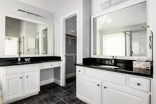 bathroom featuring vanity, a shower with shower door, and tile patterned flooring