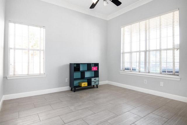 spare room with crown molding, plenty of natural light, and ceiling fan