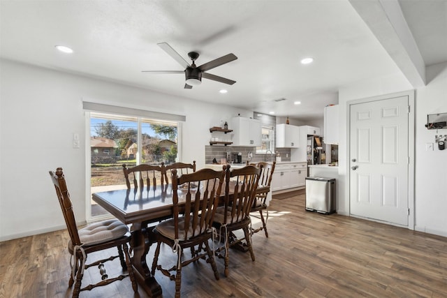 dining space with ceiling fan and dark hardwood / wood-style floors