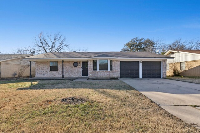 ranch-style home with a garage and a front lawn