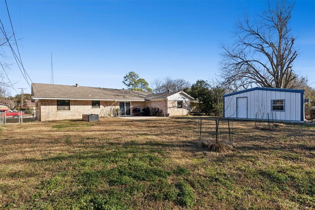 rear view of house featuring a patio and a lawn