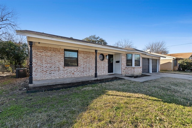 ranch-style home featuring a garage, central AC unit, and a front lawn