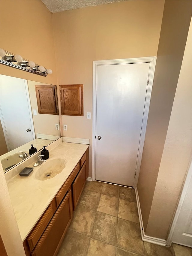 bathroom featuring vanity and a textured ceiling