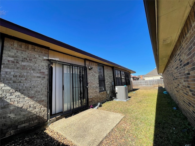 view of home's exterior featuring a yard and cooling unit