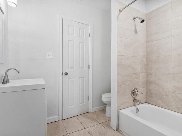 full bathroom featuring tile patterned floors, toilet, tiled shower / bath combo, and vanity