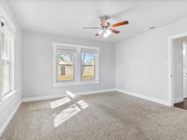 carpeted empty room featuring ceiling fan