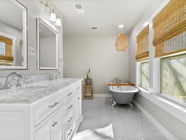 bathroom with vanity and a bathing tub