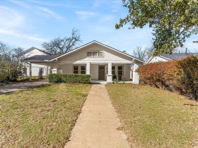 bungalow-style house with a front yard