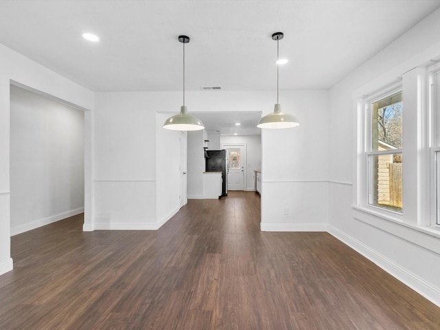 unfurnished living room featuring dark hardwood / wood-style flooring