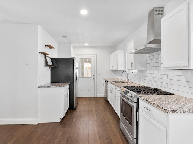 kitchen featuring sink, white cabinetry, stainless steel appliances, decorative backsplash, and wall chimney exhaust hood