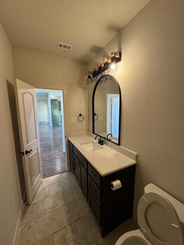 bathroom with vanity, tile patterned floors, and toilet