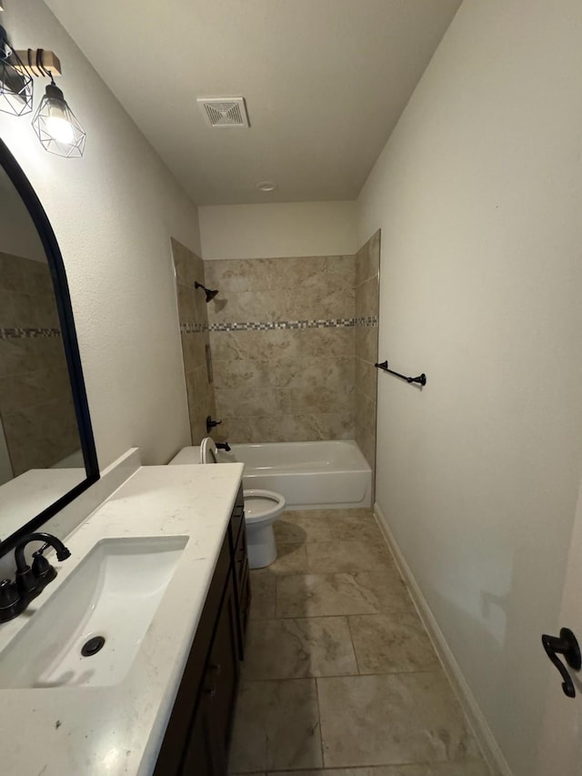 full bathroom with vanity, tile patterned flooring, toilet, and tiled shower / bath