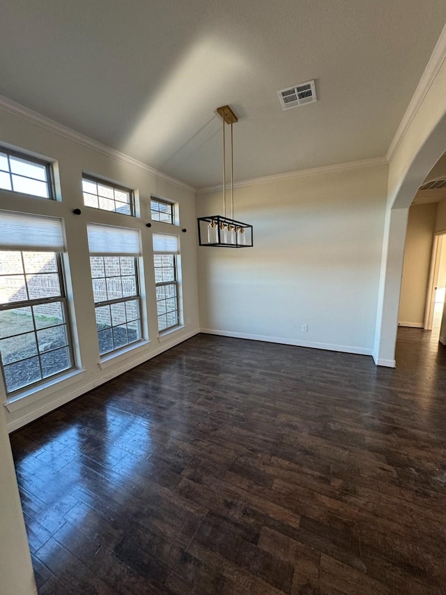 unfurnished dining area featuring ornamental molding and dark hardwood / wood-style flooring