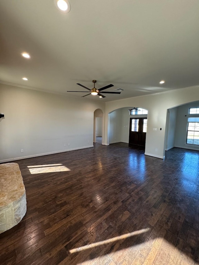 unfurnished living room featuring dark wood-type flooring and ceiling fan