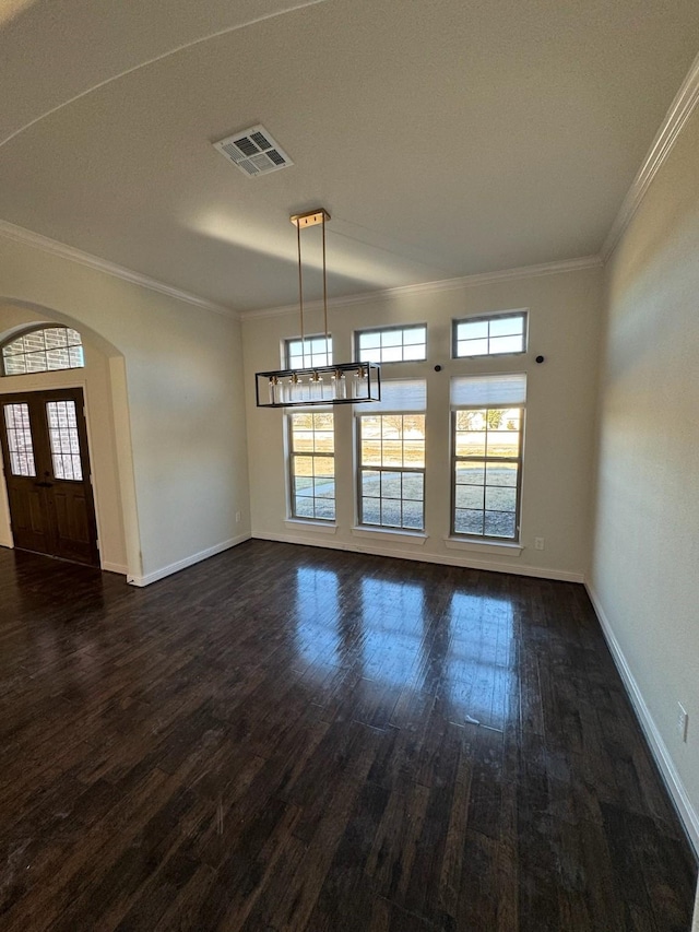 interior space featuring a wealth of natural light, dark wood-type flooring, and ornamental molding