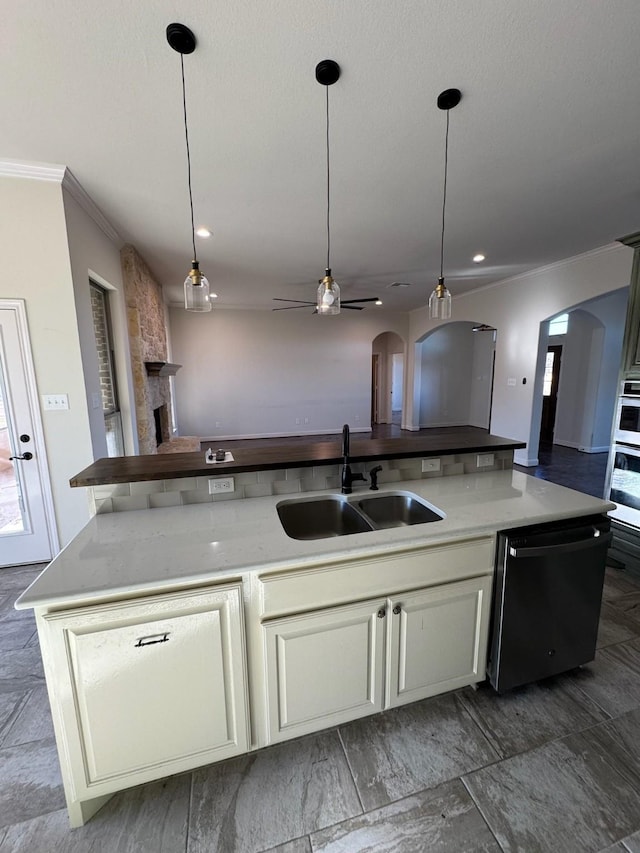 kitchen with sink, hanging light fixtures, a center island with sink, black dishwasher, and white oven