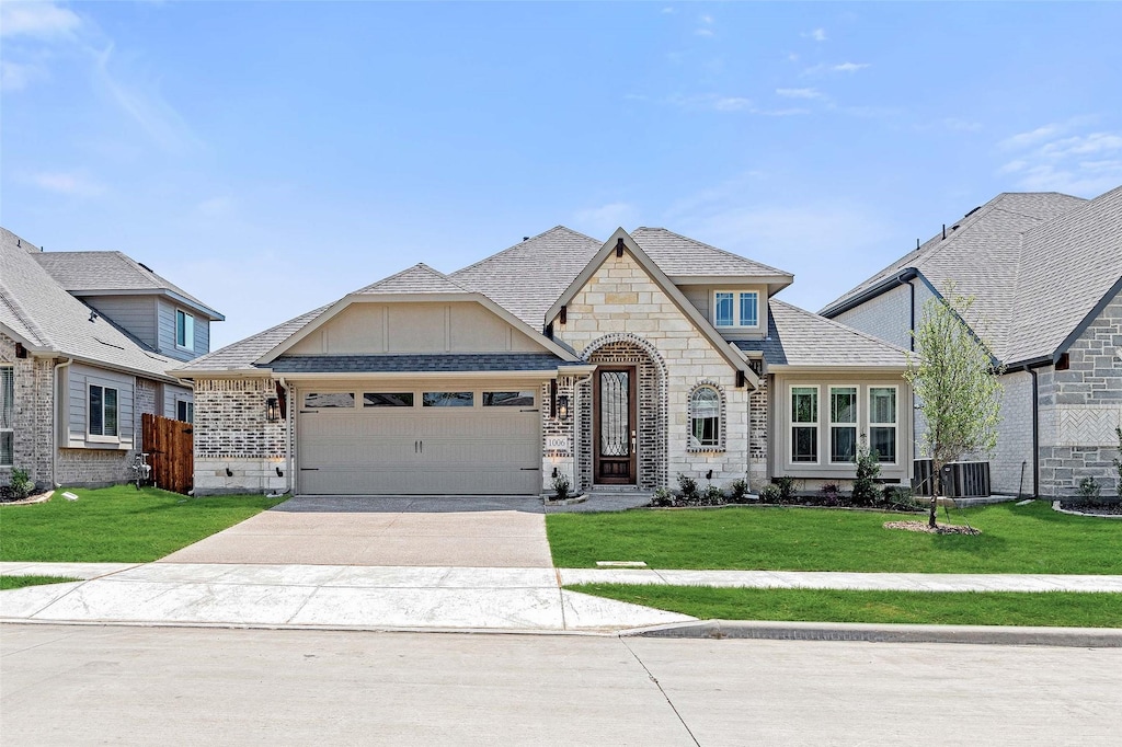 1006 Ridgehurst Rd, Melissa, TX 75454 - french country style house featuring an attached garage, a front lawn, driveway, and stone siding