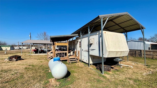 view of outbuilding featuring a carport and a yard