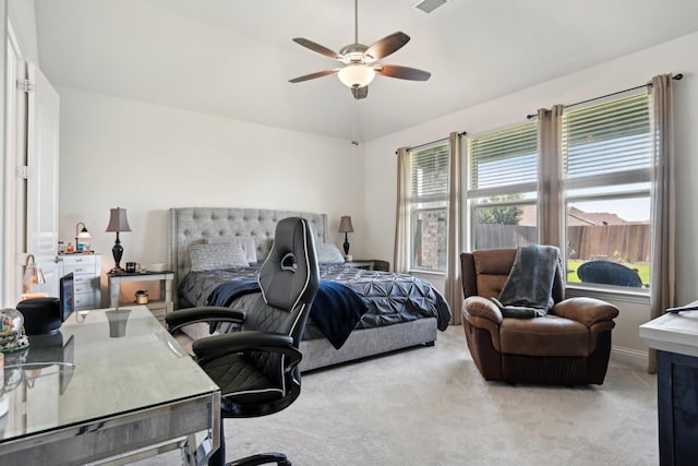 carpeted bedroom with ceiling fan and vaulted ceiling