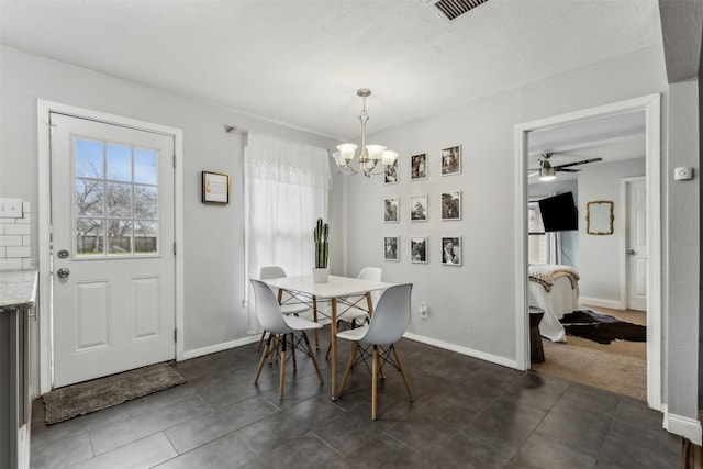 dining room with visible vents, a notable chandelier, dark tile patterned floors, and baseboards