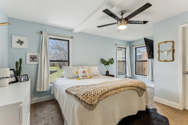 carpeted bedroom with a ceiling fan, baseboards, and beamed ceiling