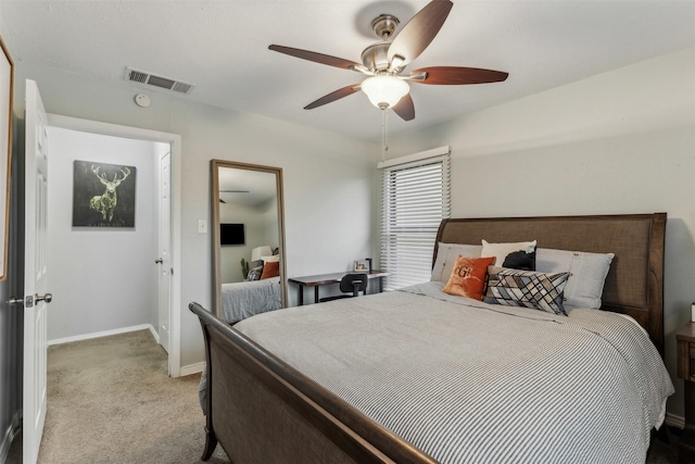 bedroom featuring a ceiling fan, light colored carpet, visible vents, and baseboards