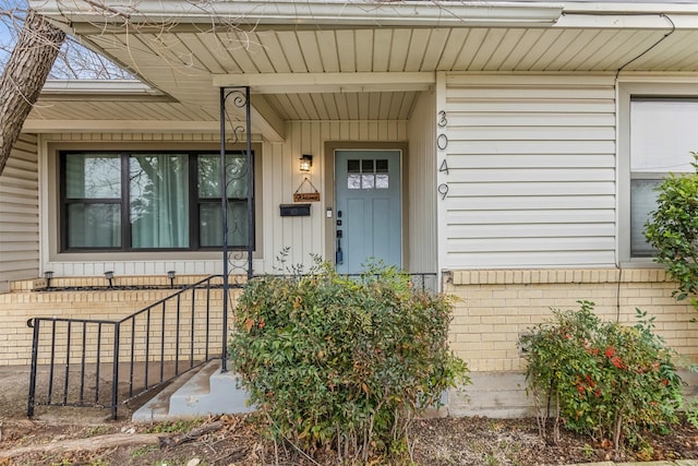 property entrance featuring brick siding