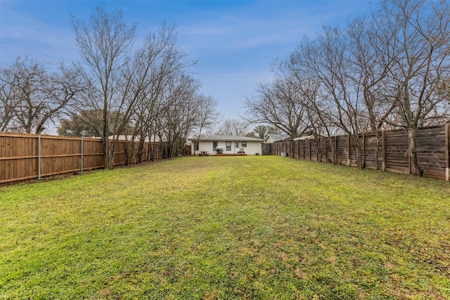 view of yard with a fenced backyard