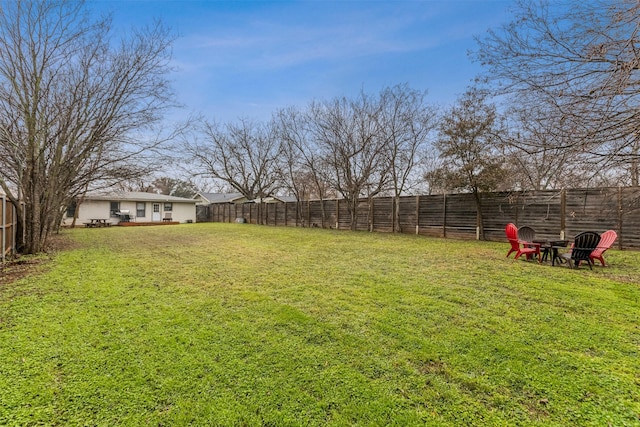 view of yard with an outdoor fire pit and a fenced backyard