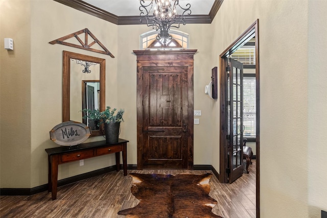 entrance foyer featuring crown molding and an inviting chandelier