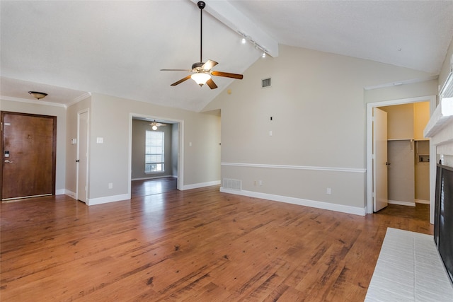 unfurnished living room featuring ceiling fan, hardwood / wood-style floors, high vaulted ceiling, a brick fireplace, and beamed ceiling