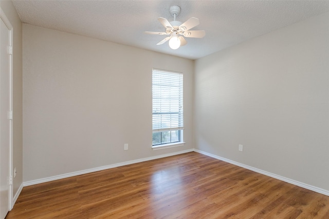 empty room with hardwood / wood-style floors, a textured ceiling, and ceiling fan