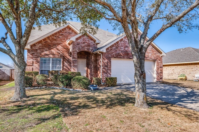 front facade featuring a garage and a front lawn