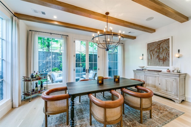 dining area featuring beam ceiling, a chandelier, and light wood-type flooring